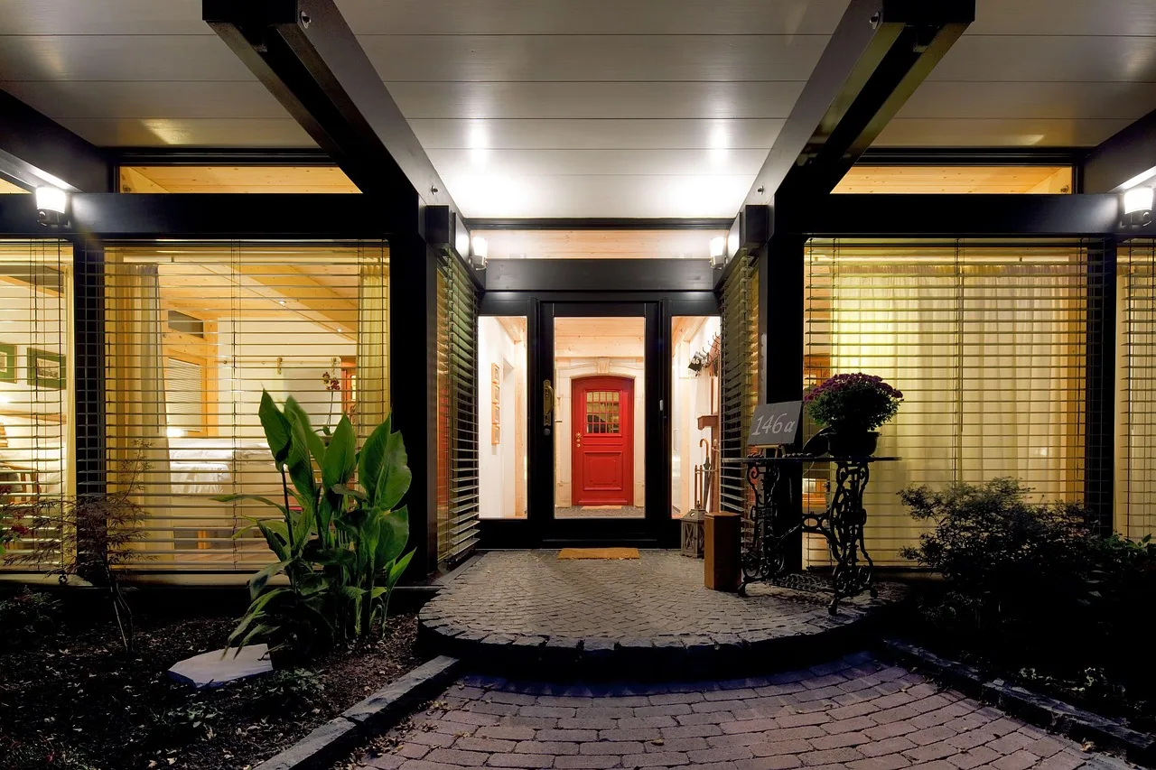 Red front door lit entry cobblestone landing black beams forest acres SC