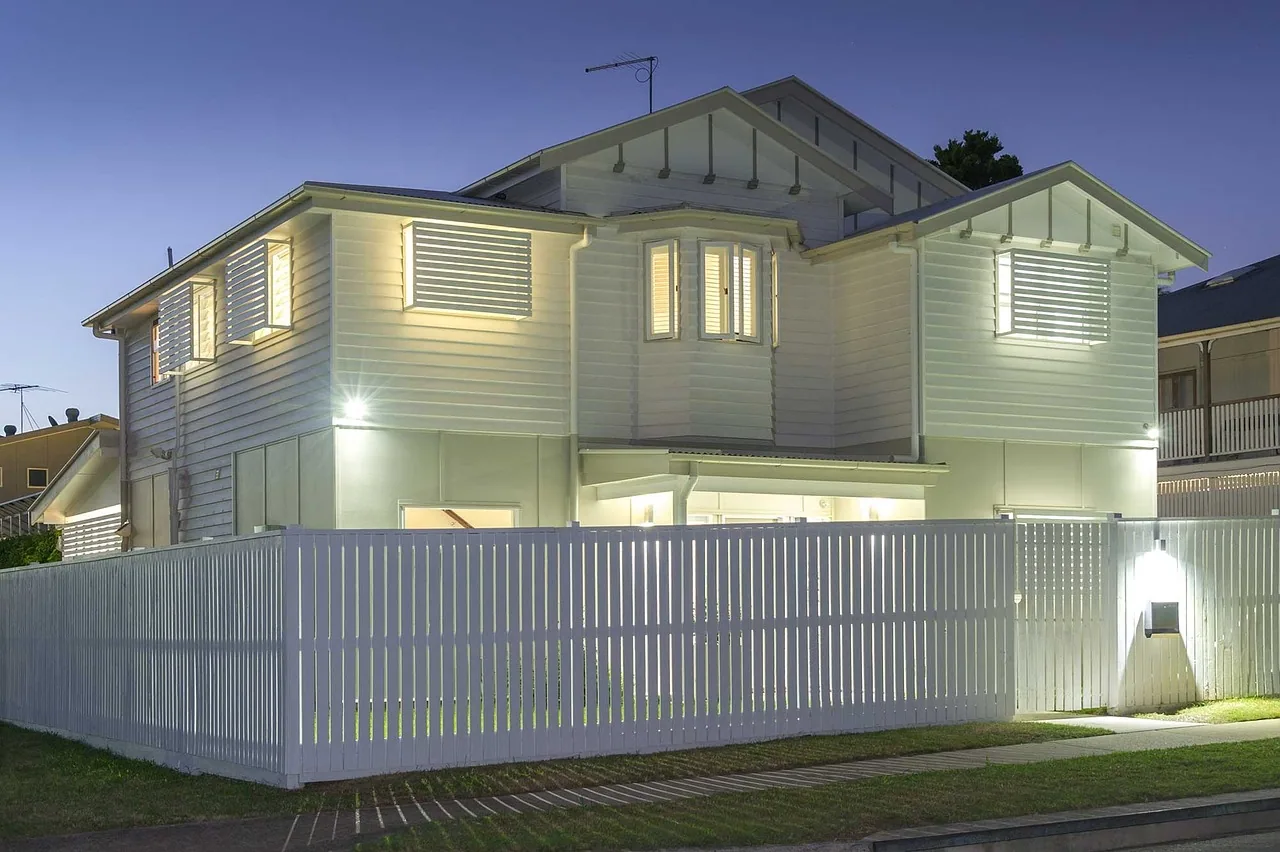 White weatherboard house picket fence wall light dusk cayce SC